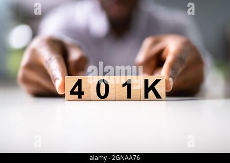 African American Man con 401K blocchi. Reddito denaro investimenti Foto Stock