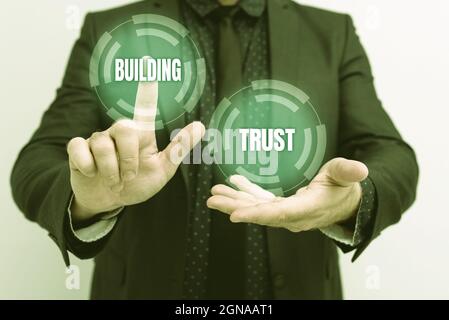 Didascalia di testo che presenta Building Trust. Parola per attività di fiducia emergente tra mostrare di lavorare efficacemente presentare nuovi piani e idee Foto Stock