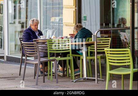 Dundee, Tayside, Scozia, Regno Unito. 24 settembre 2021. UK Meteo: Caldo sole con freschi venti occidentali in tutta la Scozia nord-orientale, temperature che raggiungono i 19°C. I residenti locali trascorrono un po' di tempo fuori godendosi il caldo sole fuori dal Costa café per rinfrescarsi nel centro di Dundee. Credit: Dundee Photographics/Alamy Live News Foto Stock