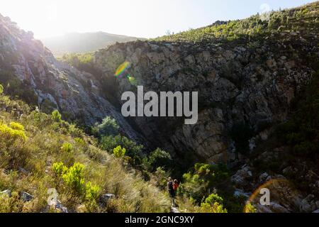 Ragazza adolescente e fratello più giovane che si snoda lungo il Waterfall Trail, Stanford, Sudafrica. Foto Stock