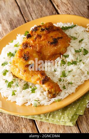 Pollo speziato alla malese Ayam Percik arrosto con riso in primo piano nel piatto. Verticale Foto Stock