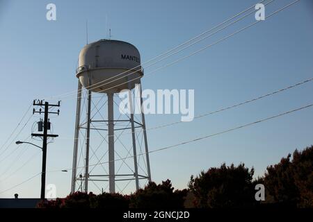 Manteca, California, USA - 15 luglio 2021: Il sole del pomeriggio splende sulla famosa torre d'acqua della città. Foto Stock