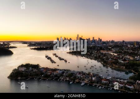 Lussuose case con terrazza residenziale sulle rive del Porto di Sydney dei sobborghi Inner City Inner West con vista aerea dell'alba verso lo skyline del CBD della città. Foto Stock