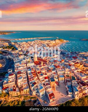 Vista dal drone volante. Fantastico paesaggio urbano mattutino di Vieste - città costiera nel Parco Nazionale del Gargano, Italia, Europa. Colofful primavera alba su Adriat Foto Stock