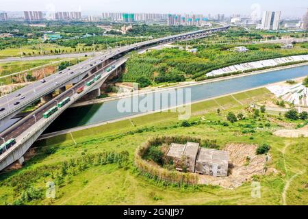 Zhengzhou, Zhengzhou, Cina. 26 settembre 2021. Il 23 settembre 2021, Zhengzhou, Henan, la ''Villa Nail Household' situata in fondo alla fossa nella cintura verde della terza circonvallazione occidentale. Dopo una pioggia pesante, il suolo intorno alla buca crollò. Quasi tutto il primo piano della casa è stato sommerso da limo ed è stato chiamato dai passanti-da ''la famiglia più miserabile del chiodo.'.questa casa è due edifici alti tre piani. È stato circondato da terra e bambù dal 2015. Il proprietario, il signor Zheng, ha detto che la gente ha vissuto qui per generazioni. Non c'è elettricità o acqua, e. Foto Stock