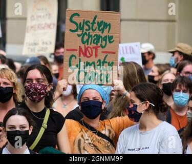 Marcia attraverso le strade parte dello sciopero guidato dagli studenti per le azioni sul clima. Cartello Cambio sistema non cambiamento climatico Foto Stock