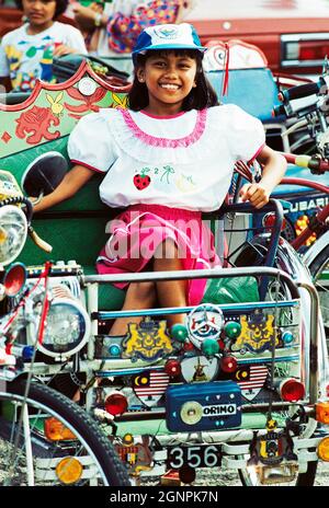 Malesia. Malacca. Donna seduta in trisaw. Foto Stock