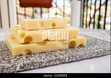 Raccolta di formaggi, emmentaler di formaggio francese semi-duro con buchi rotondi a base di latte di vacca da vicino Foto Stock