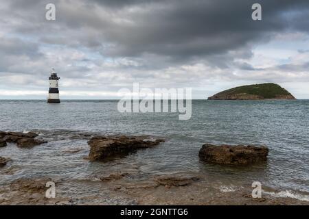 Penmon Point, Galles: Il faro di Trwyn Du e l'isola di Puffin al largo della costa anglesey, con vista sul mare irlandese e l'ingresso allo stretto di Menai. Foto Stock