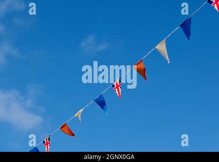 Rosso, bianco e blu, incluso Union Jack piatto attraverso il cielo blu profondo. Foto di alta qualità con spazio di copia. Foto Stock