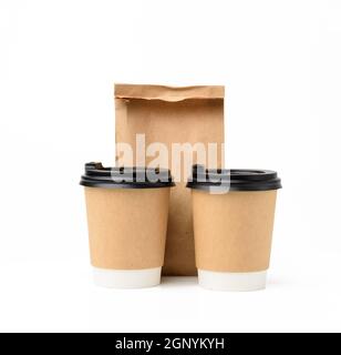 due tazze di carta marrone con coperchio in plastica e sacchetto di carta per alimenti, confezionamento ecologico e riciclabile di alimenti su sfondo bianco Foto Stock