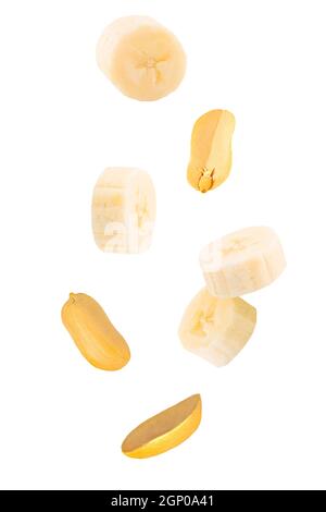 Frutta e noci isolate. Sette arachidi volanti con guscio e fette di banana bianche con percorso di ritaglio come elemento di design del pacchetto. Profondità totale del fie Foto Stock