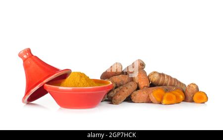 Curcuma radici e polvere in piccole tajine su sfondo bianco Foto Stock