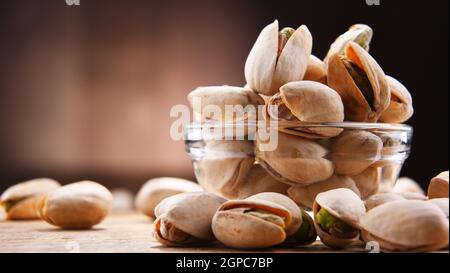 Composizione con ciotola di pistacchi a guscio. Prelibatezze Foto Stock