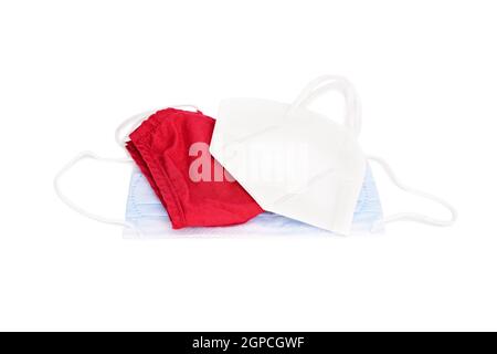 Concetto di coronavirus. Diversi tipi di maschere protettive isolate su sfondo bianco. Maschera chirurgica a 3 strati, maschera medica, KN95, cotto fatto in casa Foto Stock