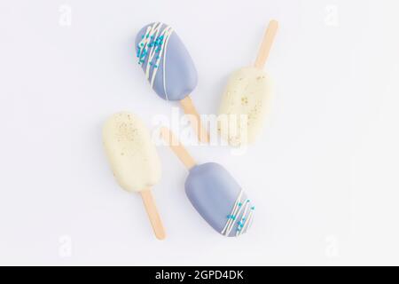 Biscotti blu e bianco gelato su un bastone su sfondo bianco. Foto di alta qualità Foto Stock
