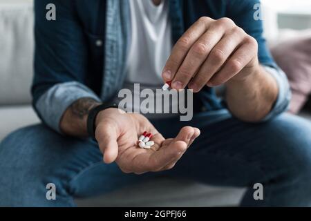 Pillole di medicina farmaceutica colorate, narcotici in capsule sul palmo Foto Stock