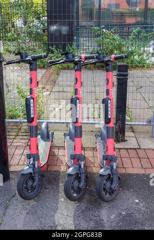 Tre voi. scooter elettrici in attesa di noleggio o noleggio a Edgbaston, Birmingham, Regno Unito Foto Stock