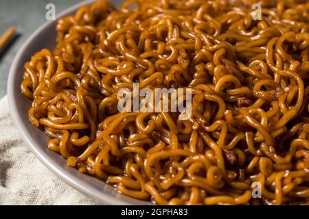 Noodle in fagioli neri Jajang fatti in casa con Chopsticks Foto Stock