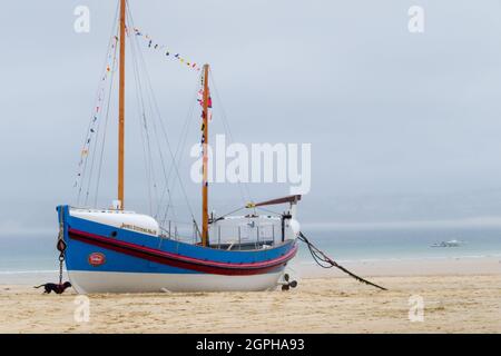 RNLI Lifeboat James Stevens No10 ormeggiato sulla spiaggia di St. Ives Harbour con bandiere Foto Stock