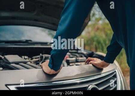 Grave guasto nella parte anteriore dell'auto e cofano aperto sul lato della strada. Concetto di auto rotta. Foto Stock