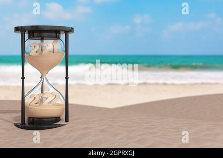 2022 concetto di vacanza di Capodanno. Sabbia che cade in Hourglass prendendo la forma da 2021 a 2022 anni su un mare deserto Coast estremo closeup. Rend 3d Foto Stock