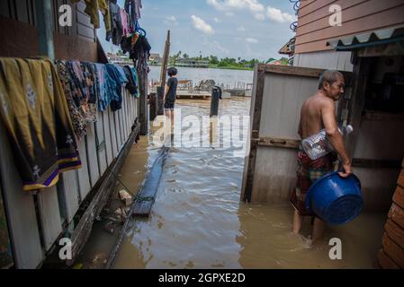 Nonthaburi, Tailandia. 30 settembre 2021. Nonthaburi residente è visto in piedi tenendo una bottiglia in acqua allagata durante il postemath.After tropicale tempesta di Dianmu, un diffuso di inondazioni in 30 province nel centro e nord-est della Thailandia. Il governo ha annunciato la situazione delle inondazioni in 9 province, tra cui Bangkok, Nonthaburi, Patum thani, Chai Nat, Sing Buri, Ang Thong, Ayutthaya, Sara Buri e Lop Buri. Che la situazione debba essere controllata giorno per giorno. Credit: SOPA Images Limited/Alamy Live News Foto Stock