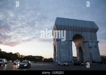 Parigi, Francia, 30 settembre 2021: L'Arco di Trionfo di Parigi, avvolto in tessuto d'argento come progettato dagli artisti Christo e Jeanne-Claude, e che attrae un flusso costante di turisti. Questo fine settimana, la Place Charles de Gaulle che circonda l'arco sarà chiusa al traffico, consentendo visite più sicure rispetto a coloro che hanno catturato alcuni colpi dal centro dei viali che irradiano dalla rotonda. L'installazione artistica sarà smantellata da lunedì 4 ottobre per consentire le celebrazioni del giorno dell'armistizio. Anna Watson/Alamy Live News Foto Stock