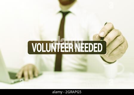 Scrittura di testo visualizzazione Volontario necessario. Parola per cercare l'assistente per fare il compito senza pagare o compensazione lavoro di ufficio remoto in linea presentare Foto Stock