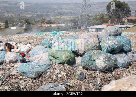 Nakuru, Rift Valley, Kenya. 1 ottobre 2021. Le donne sono viste smistare i rifiuti delle bottiglie di plastica nel sito di scarico di Gioto per essere portati in un impianto di riciclaggio vicino.il problema crescente dei rifiuti di plastica che finiscono nell'ambiente sta diventando una preoccupazione e gli ambientalisti stanno chiedendo più investimenti nelle infrastrutture per riciclare la plastica per promuovere l'economia circolare e ridurre l'inquinamento della plastica. Essi chiedono inoltre al governo di introdurre un sistema obbligatorio di deposito e rimborso delle bottiglie (DRS) che darà valore alle bottiglie di plastica per bevande comunemente note come animali da compagnia (polietilentereftalato). Cr. DEP Foto Stock