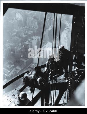 EMPIRE STATE BUILDING NY, NY 1930 - 1931. Viste generali e dettagliate dell'Empire state Building in costruzione che mostrano i lavoratori che svolgono varie attività, tra cui posizionamento, saldatura e rivettatura dell'acciaio, sollevamento di materiali e forniture, funzionamento e riparazione di macchinari. Ci sono anche vedute a volo d'uccello del centro di Manhattan che mostrano altri edifici in costruzione. Fotografie di: Hine, Lewis Wickes, 1874-1940 . Foto Stock