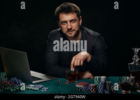 Uomo bearded del giocatore in linea del casino che celebra la vittoria Foto Stock