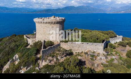 Vista aerea dei resti della torre genovese sul Capo Campomoro nel sud della Corsica, Francia - Torra di Campumoru circondata da mura su un belvedere Foto Stock