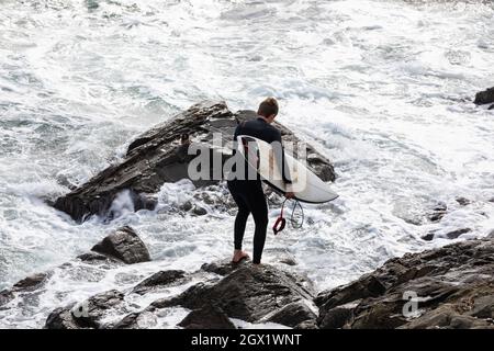 I surfisti possono godersi i mari in una giornata autunnale soleggiato e ventilata a Porthleven, Cornovaglia. Foto Stock