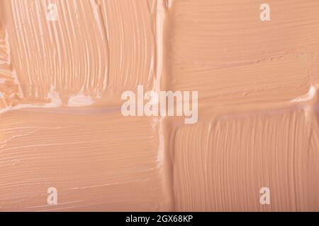 Macchia di fondo liquido, colore beige.sfondo cosmetico. Foto Stock
