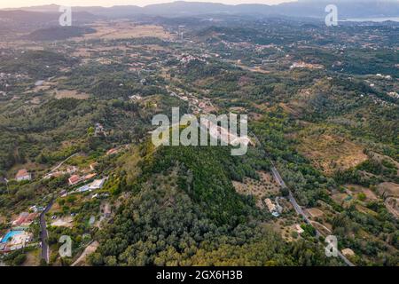 Vista aerea del drone sul tipico paesaggio rurale nell'isola centrale di Corfù al tramonto, in Grecia. Foto Stock