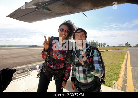 Salto in paracadute tandem. Bella donna brasiliana. Foto Stock