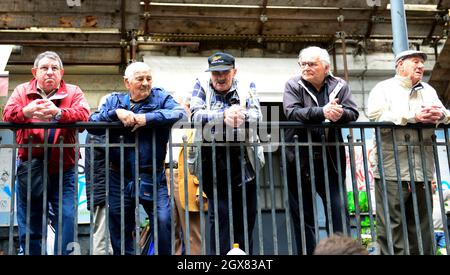 Uomini siciliani che guardano verso il basso il colorato mercato del pesce mattutino a Catania, Italia. Foto Stock