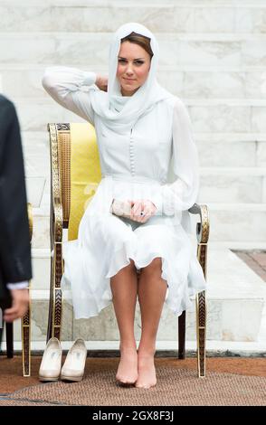 Catherine, Duchessa di Cambridge rimuove le scarpe e indossa un velo mentre visita la Moschea di Assyakirin a Kuala Lumpur il 4° giorno di un tour del Giubileo dei Diamanti dell'Estremo Oriente. Foto Stock