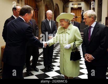 La Regina accompagnata dal presidente George Reid (a destra) scuote le mani con il primo ministro scozzese Jack McConnell al Parlamento scozzese di Edimburgo, dove incontrava i leader del partito. Lunghezza 3/4, cappello, Royals Foto Stock