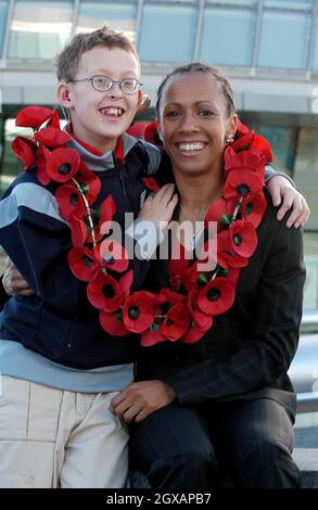 Kelly Holmes ha lanciato l'appello britannico di papavero della Legione sul terrapieno fuori dal municipio, giovedì 21 ottobre. Colin di dodici anni, che soffre di una malattia degenerativa, è uno dei giovani che la Legione ha recentemente aiutato. Foto Stock