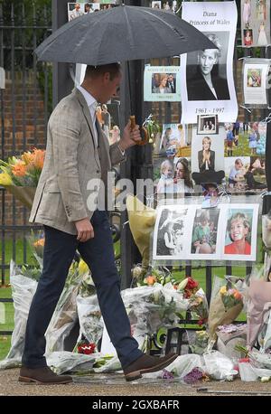 Il Duca di Cambridge guarda agli omaggi lasciati dal pubblico dedicato alla madre Principessa Diana in seguito alla loro visita al Giardino Bianco, dedicato alla memoria della Principessa Diana, a Kensington Palace, Londra, il 30 agosto 2017. Foto Stock