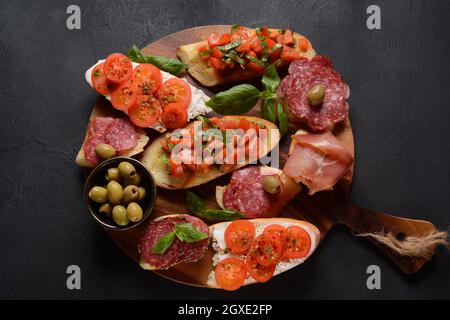 Bruschetta assortita con vari condimenti. Bruschetta o crostini appetitosi. Varietà di piccoli panini. Foto Stock
