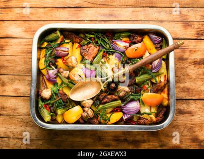 Carne alla griglia e verdure su sfondo rustico di legno. Carne arrosto con verdure nel vassoio Foto Stock