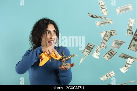 Donna è felice becaouse lei fonda lampada di aladdin e ha chiesto soldi Foto Stock