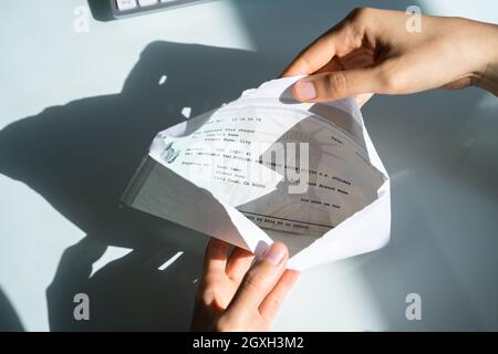 Assegno di retribuzione nella busta. Donna mano che tiene il controllo di paga Foto Stock