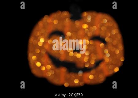 Pumpkin Jack o Lanterna con glitter sfocato Foto Stock