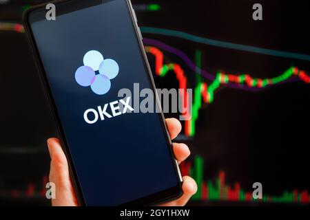 Ucraina, Odessa - 7 settembre 2021: L'app mobile OKEx in esecuzione sullo schermo dello smartphone con grafico a candelabro di trading sullo sfondo. OKEx è una piattaforma di scambio e scambio di criptovaluta Foto Stock