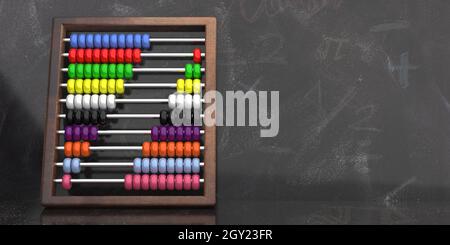 Abacus su sfondo lavagna. I bambini imparano a contare, a scuola, le attrezzature tradizionali per la matematica di base, le perle di colore e la cornice di legno. Copia s. Foto Stock