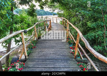 Un'incantevole passerella in legno verso Stara Koliba, un ristorante tradizionale sulle sete del Danubio a Belgrado, in Serbia Foto Stock